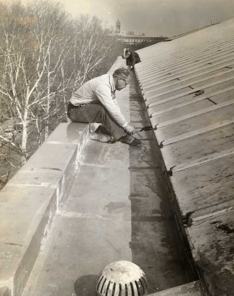 Workers installing new steel gutter